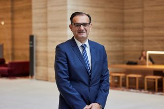 man in a suit smiling 