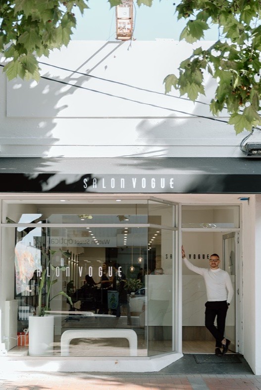 man standing in from on hair salon, Salon Vogue Hair