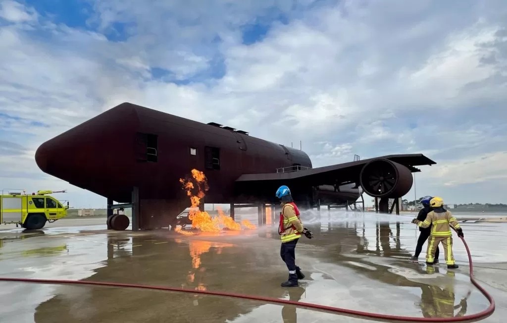 Girls on Fire particpant helping put out a fire