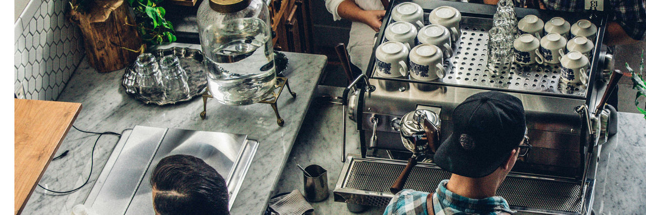 Overhead shot of barista machine and worker