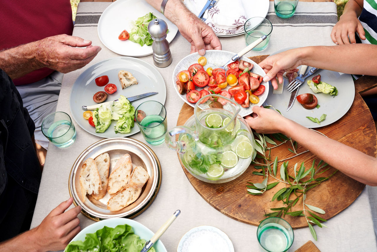 People sharing food at an outdoor lunch table