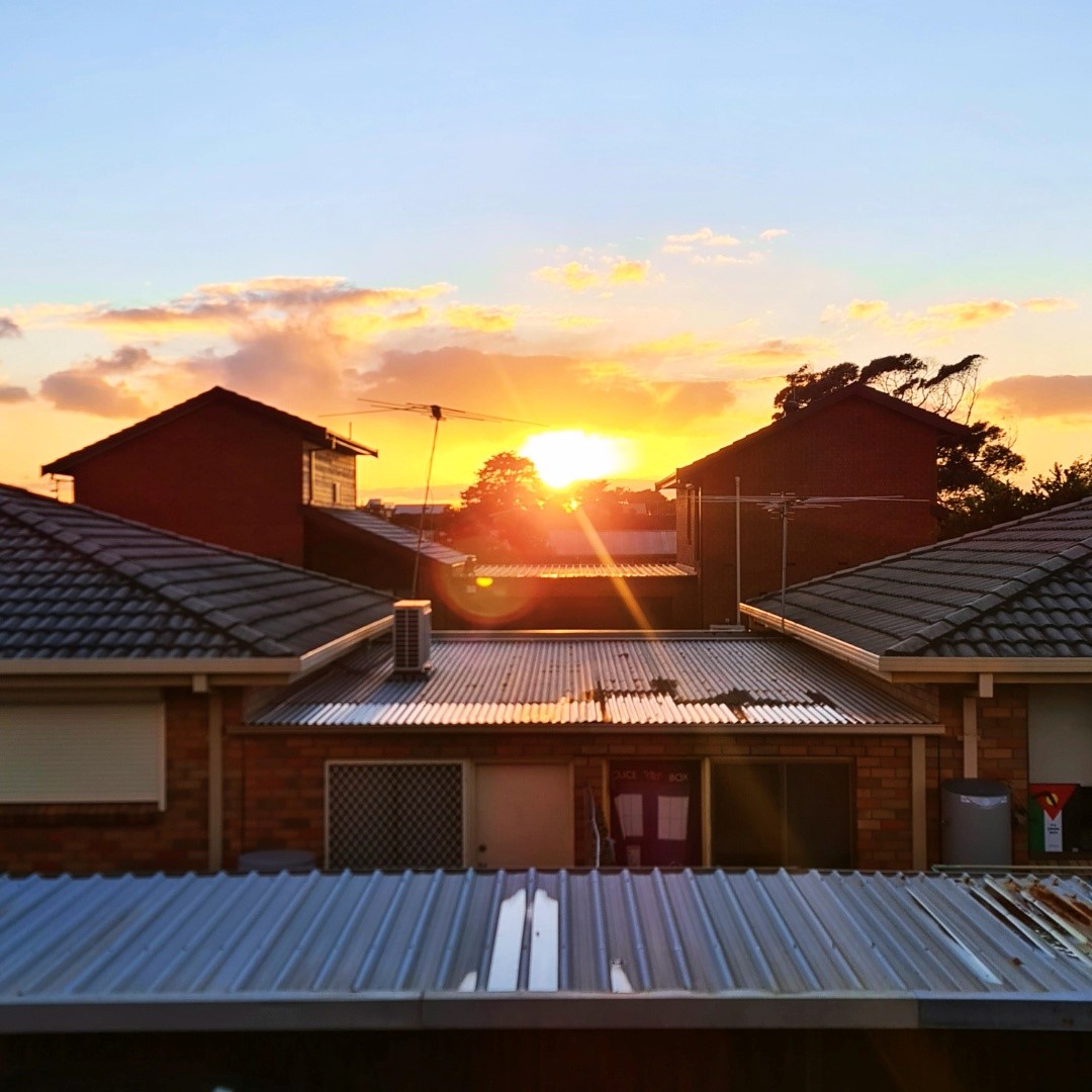 sunset behind houses