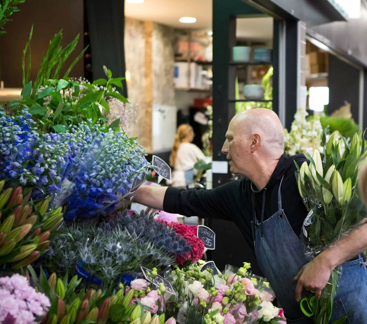 Florist arranging flowers in shop front