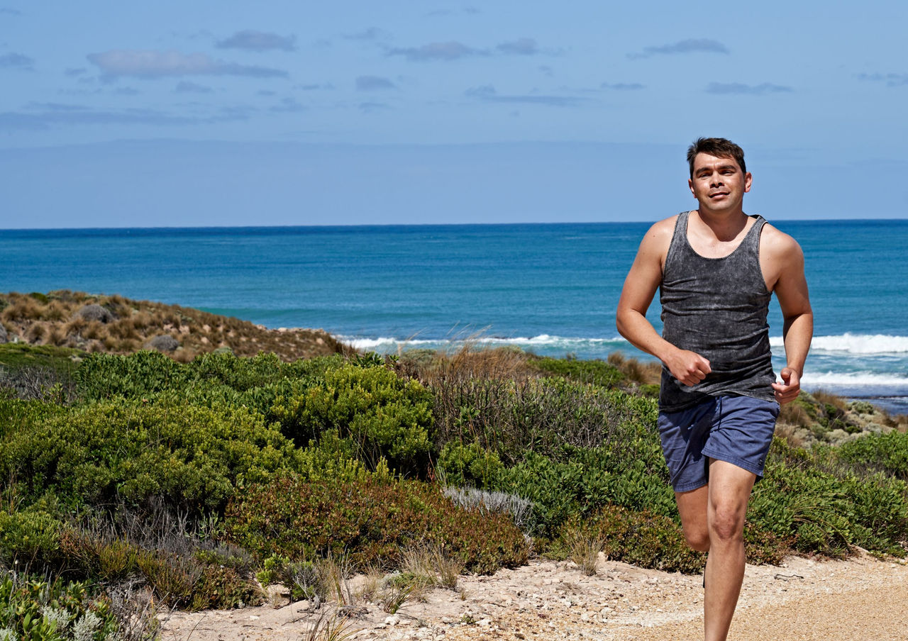 young man running on beach