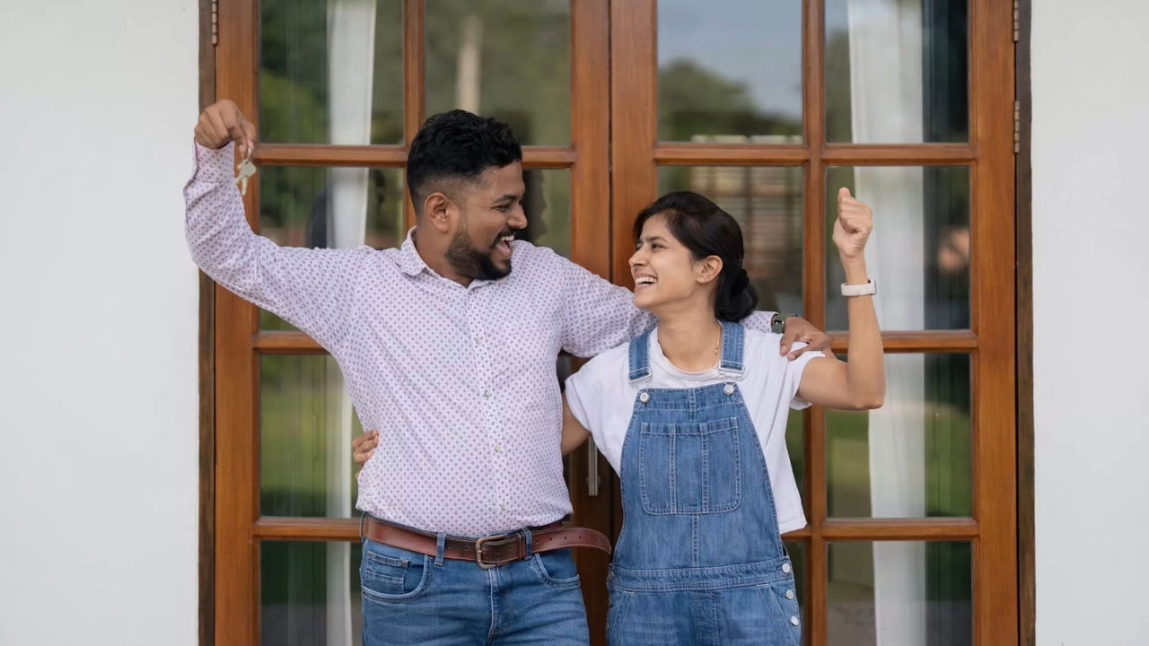 couple holding keys to new home