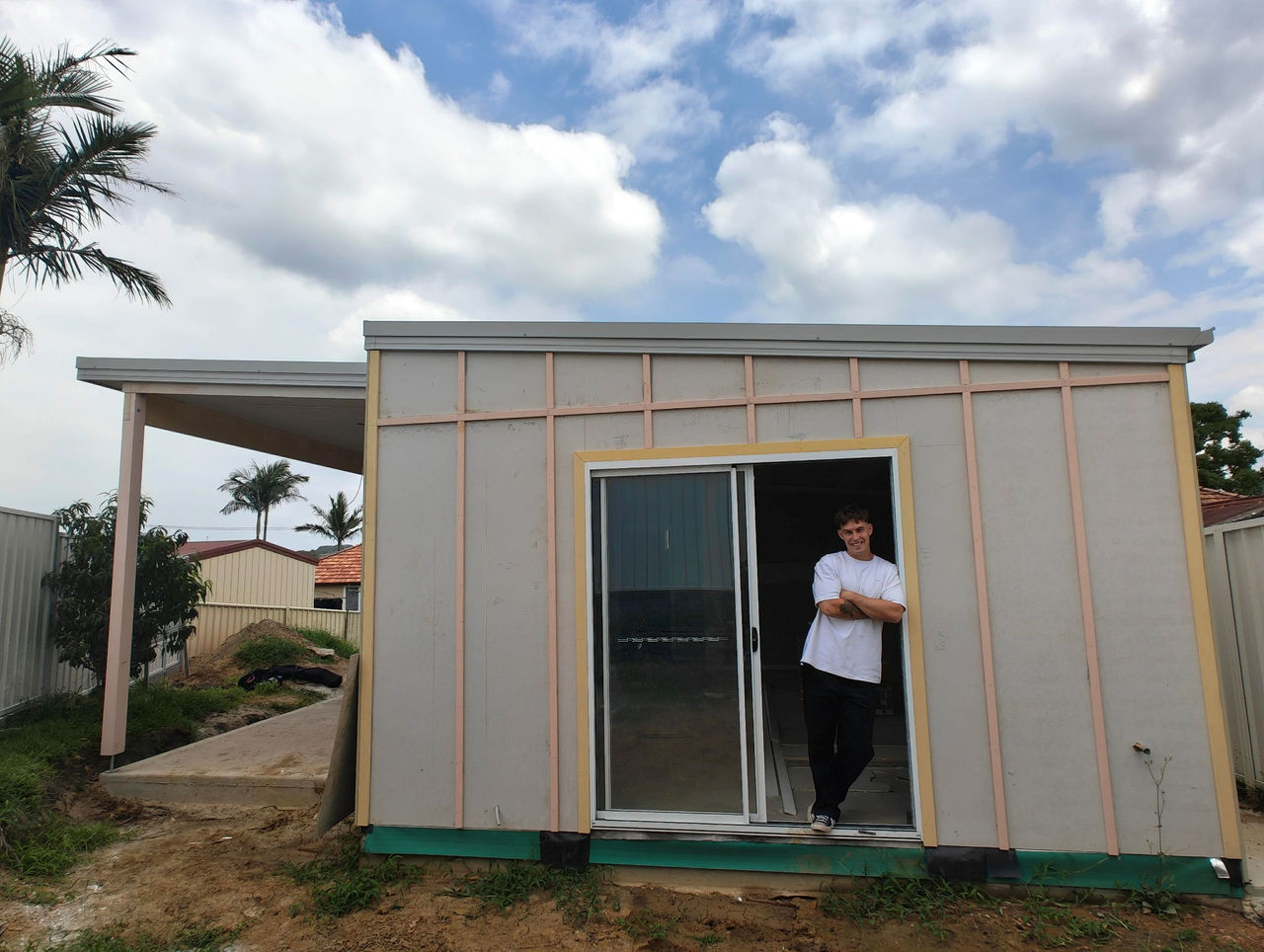 man standing at granny flat entrance