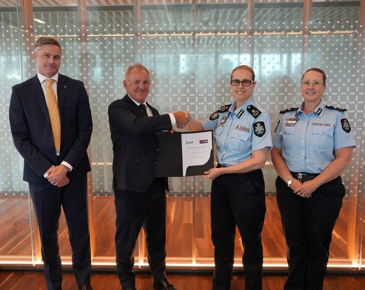 AFP Deputy Commissioner National Security Investigations Hilda Sirec and NAB Group Chief Risk Officer Shaun Dooley signing the renewed MoU