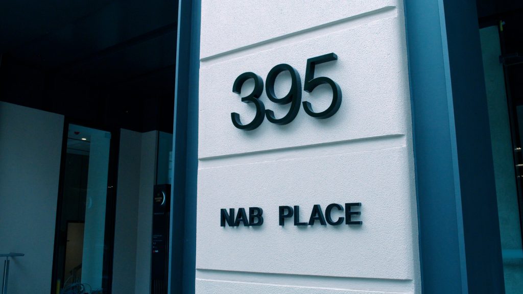 A photo shows the facade of NAB's Melbourne office 'NAB Place' at 395 Bourke Street. 