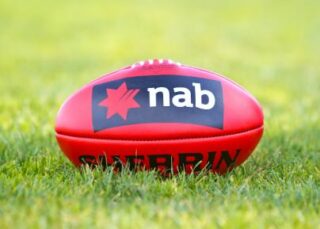AFL football with NAB logo on the grass. 