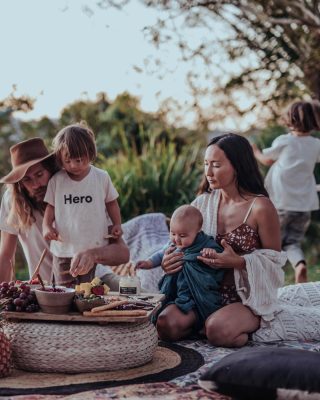 A man, woman and two children eat together.