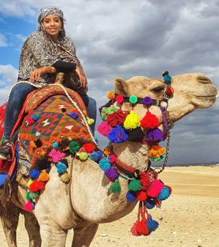 A woman, Alaa Karrar, on a camel