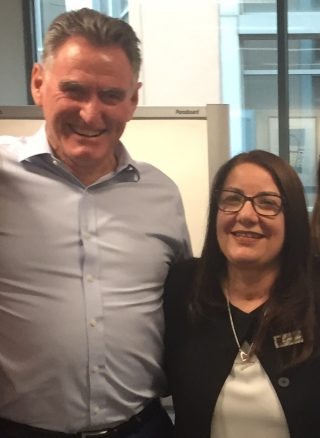 Man and woman smiling in an office