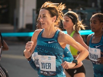 Woman running in race with other runners