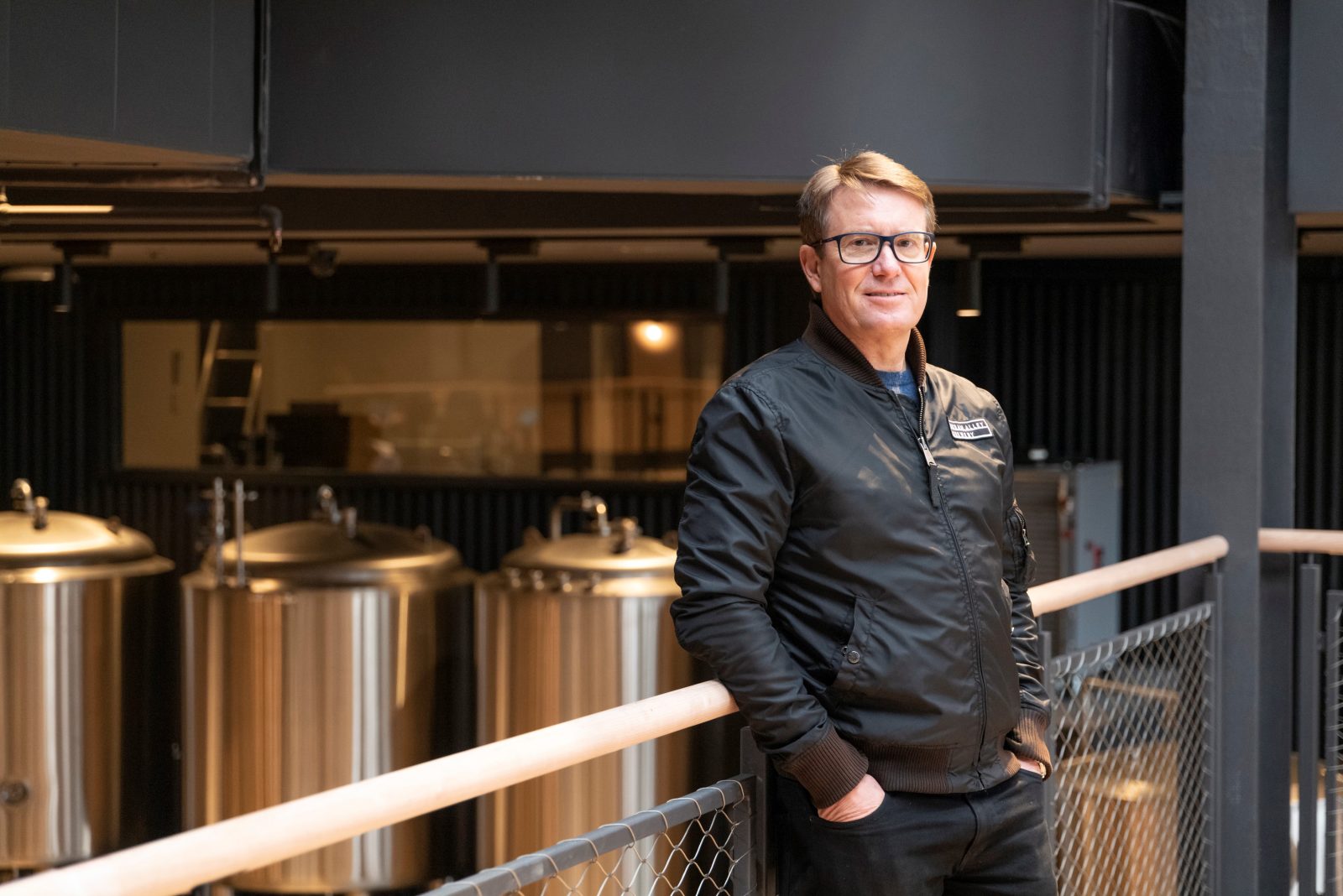 Man in front of brewing equipment