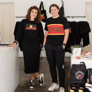 Photograph of two women standing wearing Clothing The Gaps t-shirts.