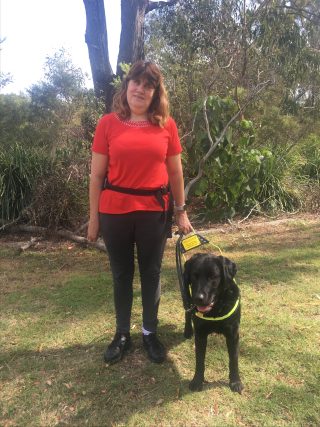 Woman smiling with her dog from Seeing Eye Dogs Australia