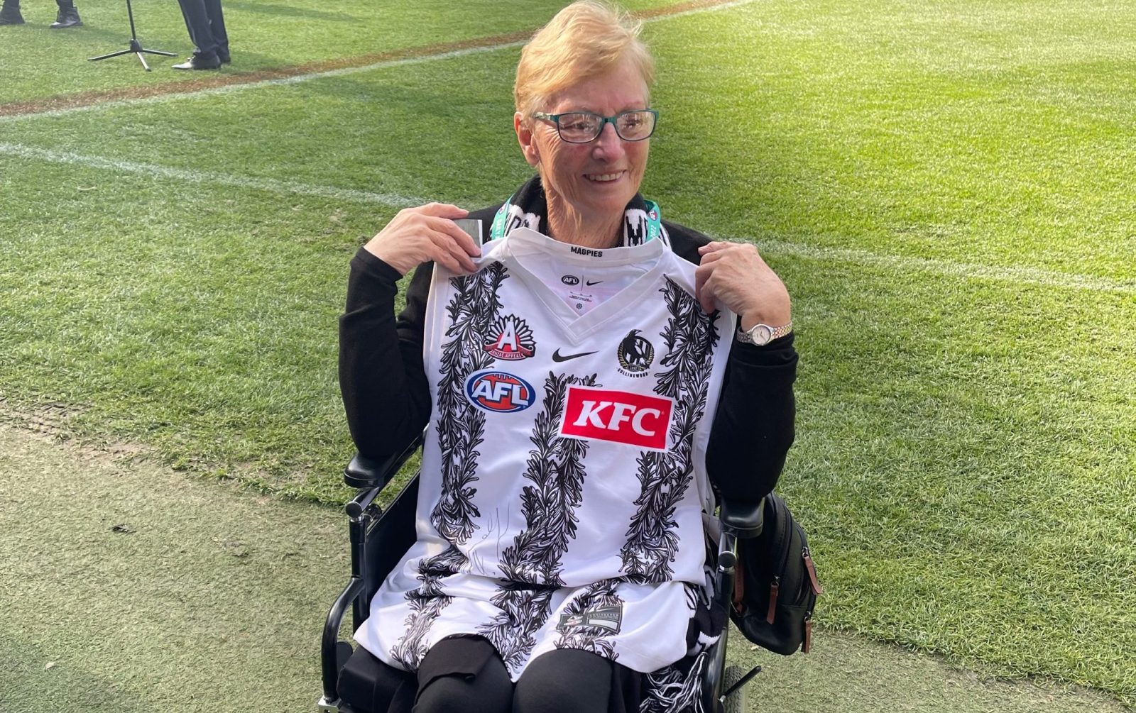 Photograph of woman in a wheelchair holding a Collingwood gurnsey