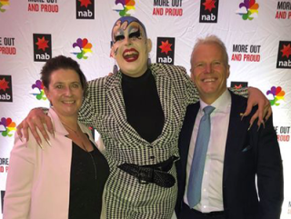 Drew standing next to a drag queen at a NAB Pride event