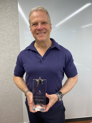 Drew Bradford (wearing purple) with NAB's Australian LGBTQ Inclusion Award