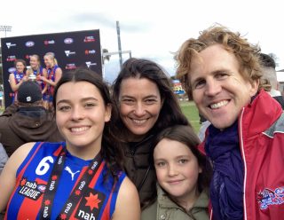 Emma and her daughters at a footy match
