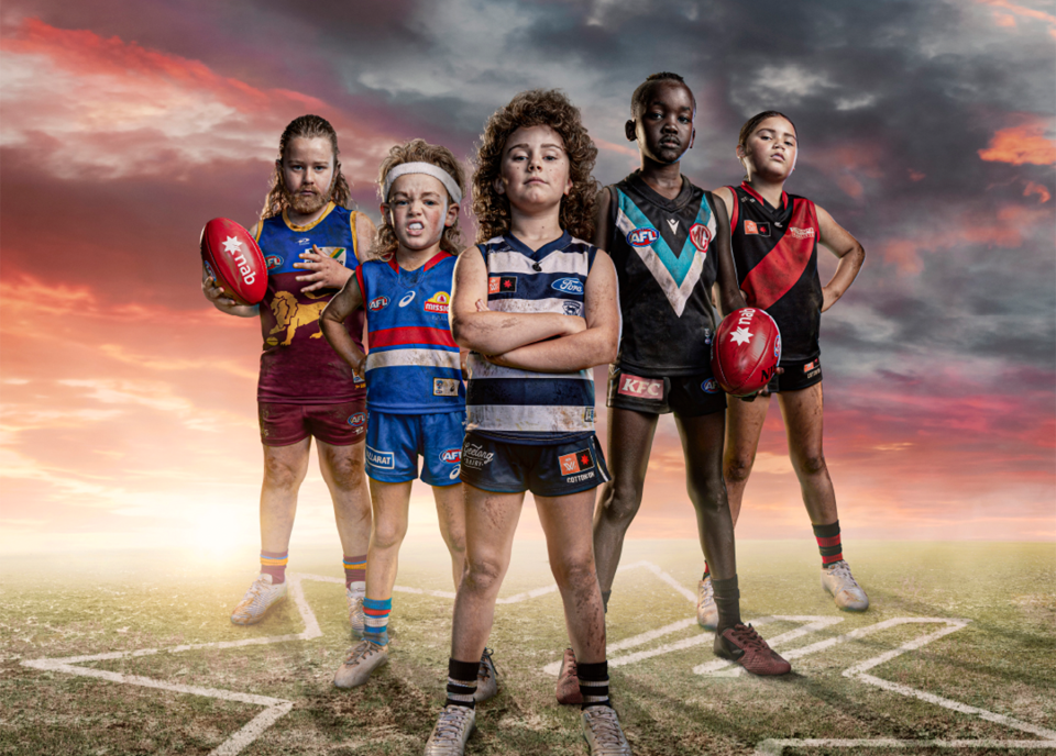 Photograph of five children dressed up as AFL and AFLW players