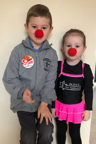Two children - Miller and Lucy - wearing red noses