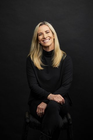 psychotherapist Lissy sitting down and smiling for a photo shoot