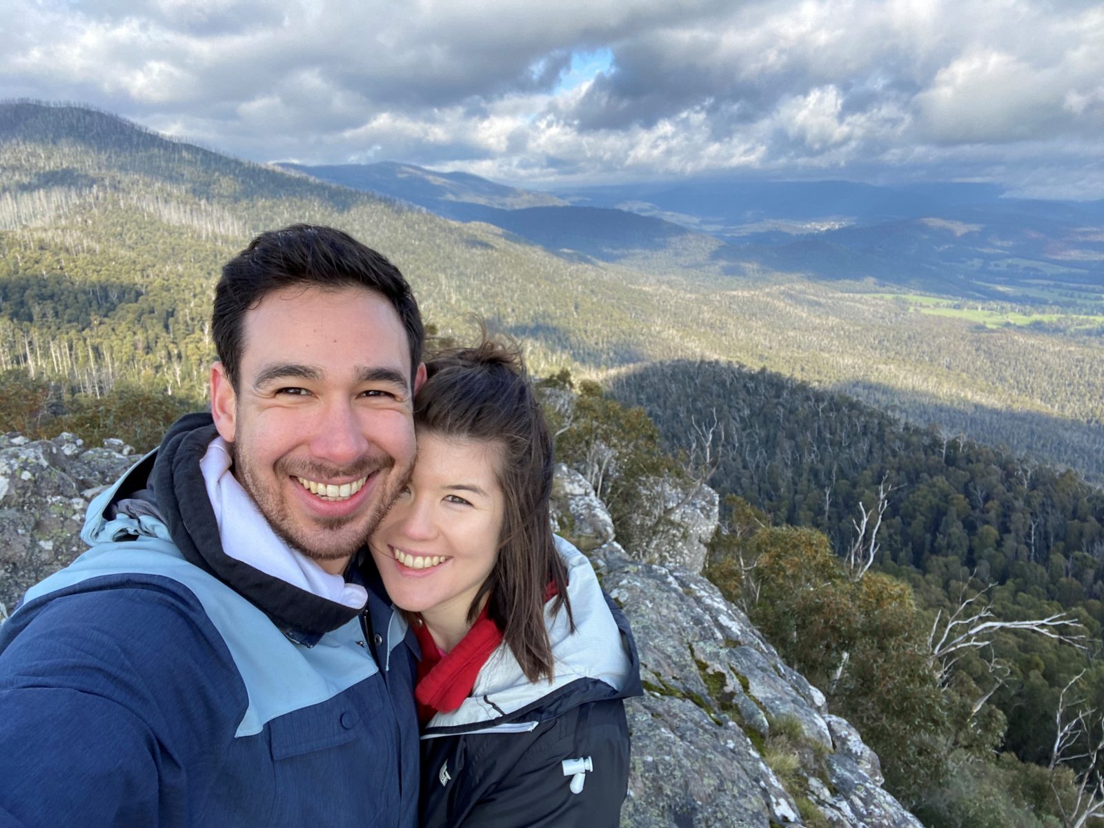 Young couple Dan and Naomi taking a selfie with mountains as backdrop