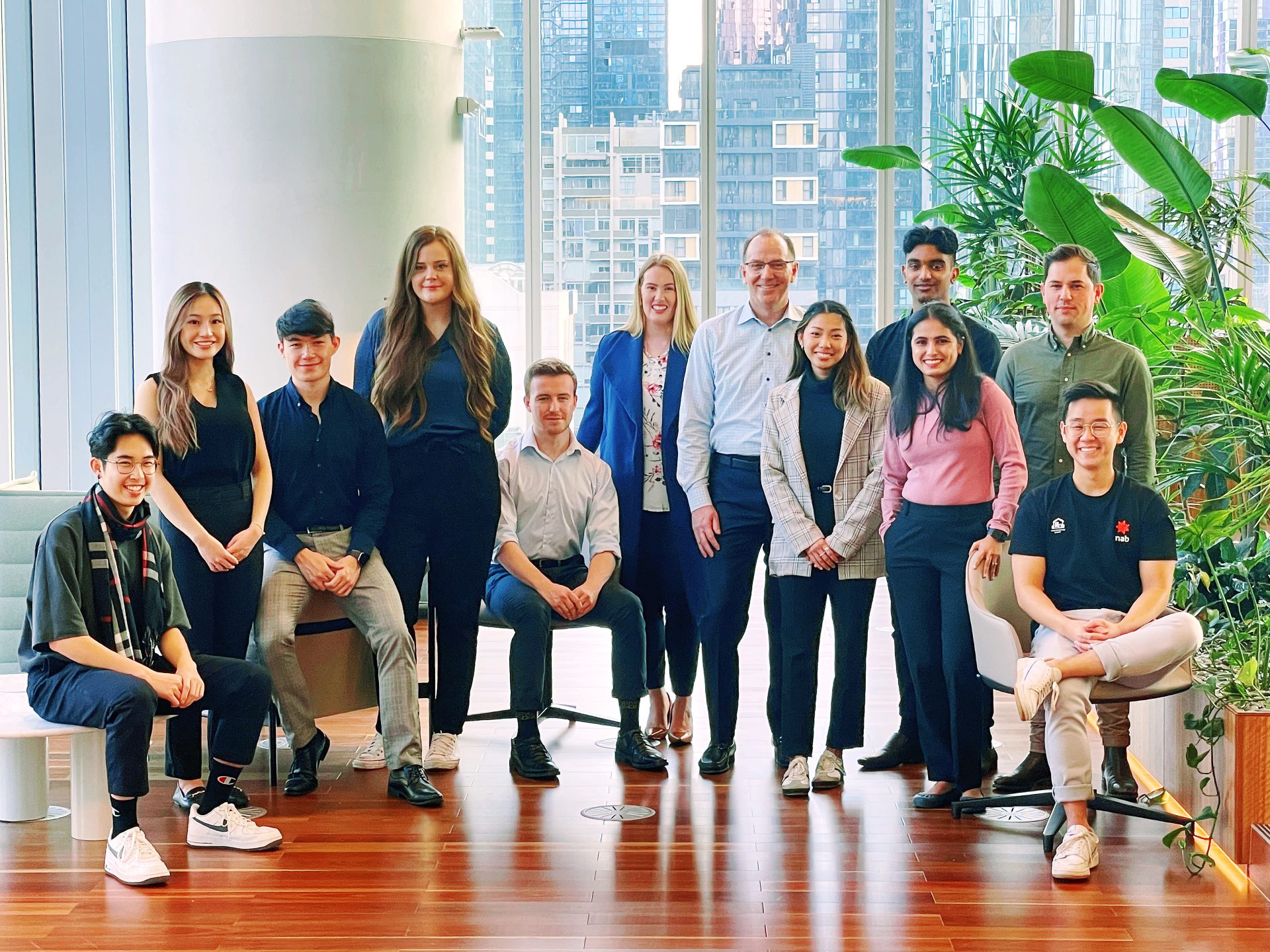 Patrick Wright standing with 11 technology interns