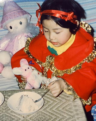 Young girl - Enqi - holding a toy kangaroo