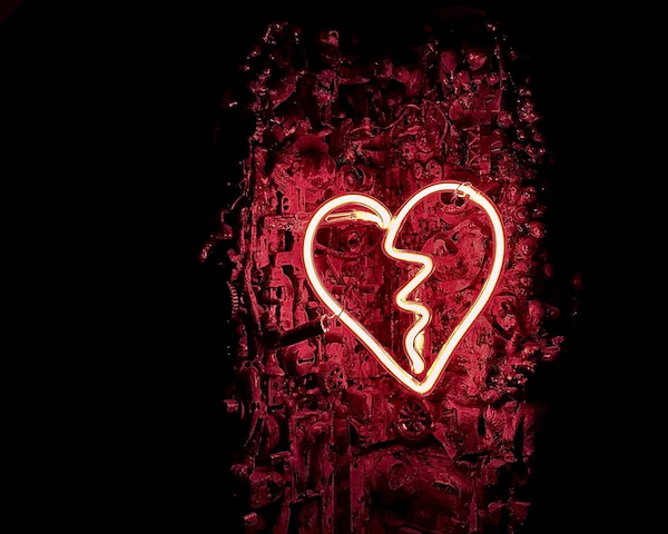 Red neon lights in the shape of a broken heart