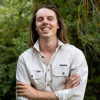 Tahbilk’s Lachie Thomas, wearing a Tahbilk shirt and smiling at camera