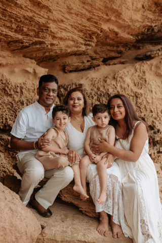 A family photo in front of a rock formation, including Darsh, her parents and two boys.