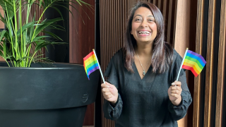 NAB colleague Darshika Prasad, holding two rainbow flags