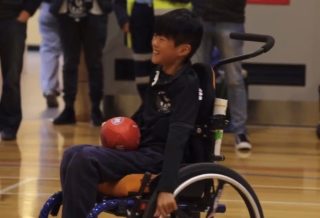 Boy playing wheelchair football