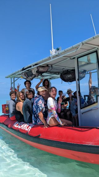 Several Indigenous young people on a small boat