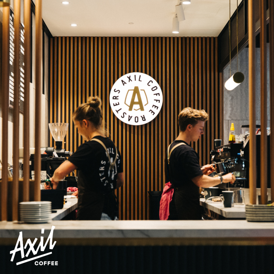 Two baristas preparing coffees at Melbourne-based, Axil Coffee Roasters