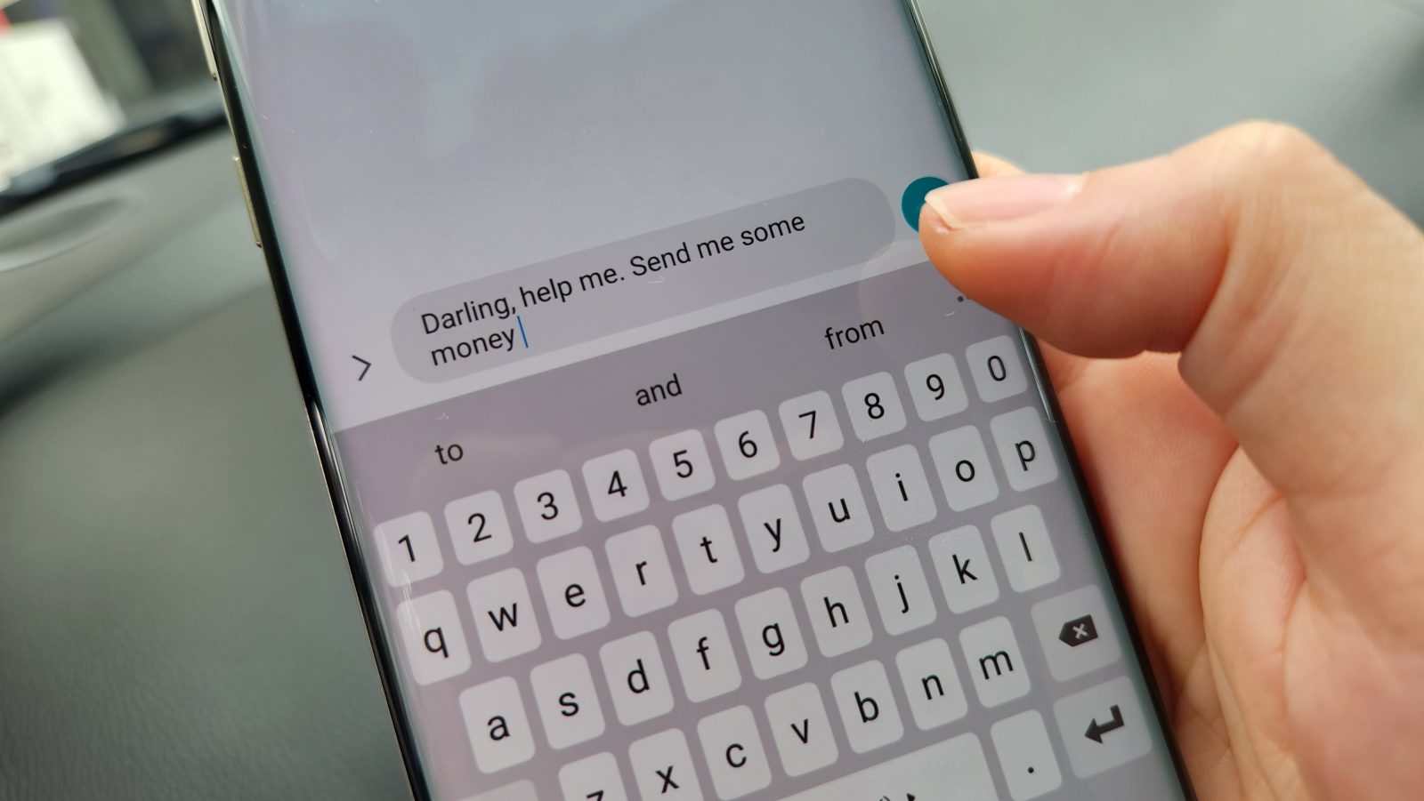 A hand holding a mobile phone with text message showing a potential romance scam.