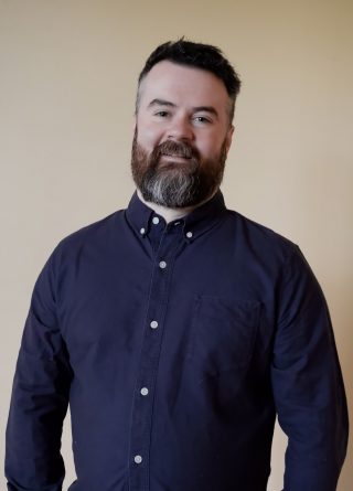 Image of a man in a blue shirt 