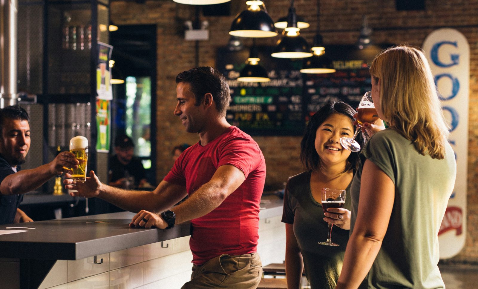 People in bar getting a drink.