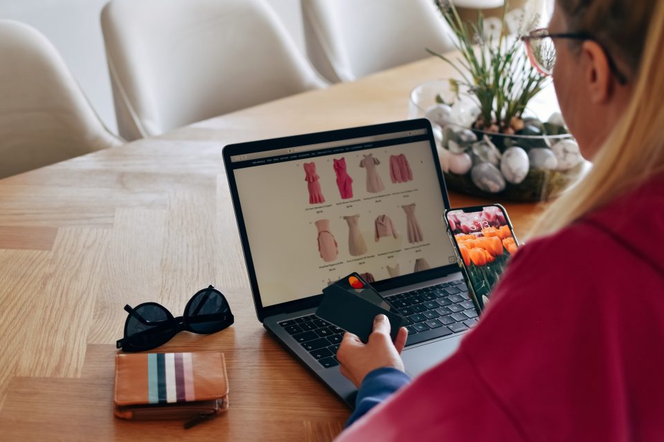 women at a computer at a table doing online shopping