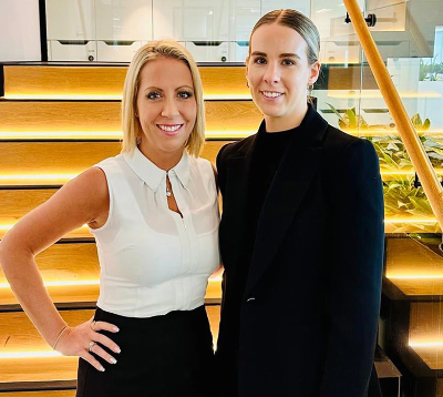 image of two women in front of a set of stairs