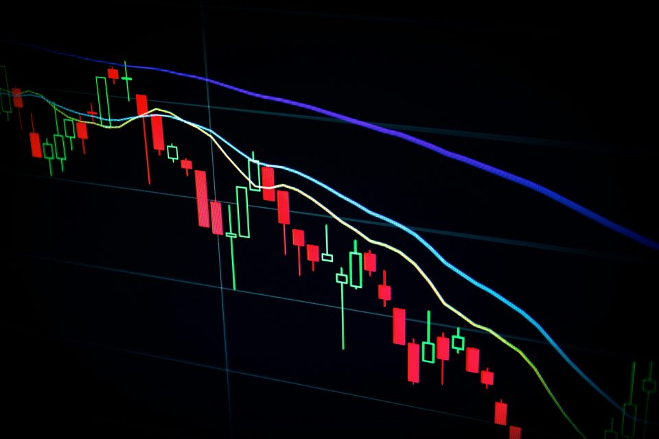 graphs showing the movement of stocks or money on a black background