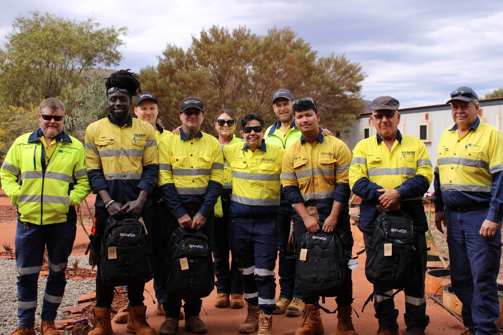 Tammy O'Connor and King Kira crew wearing standing on a work site