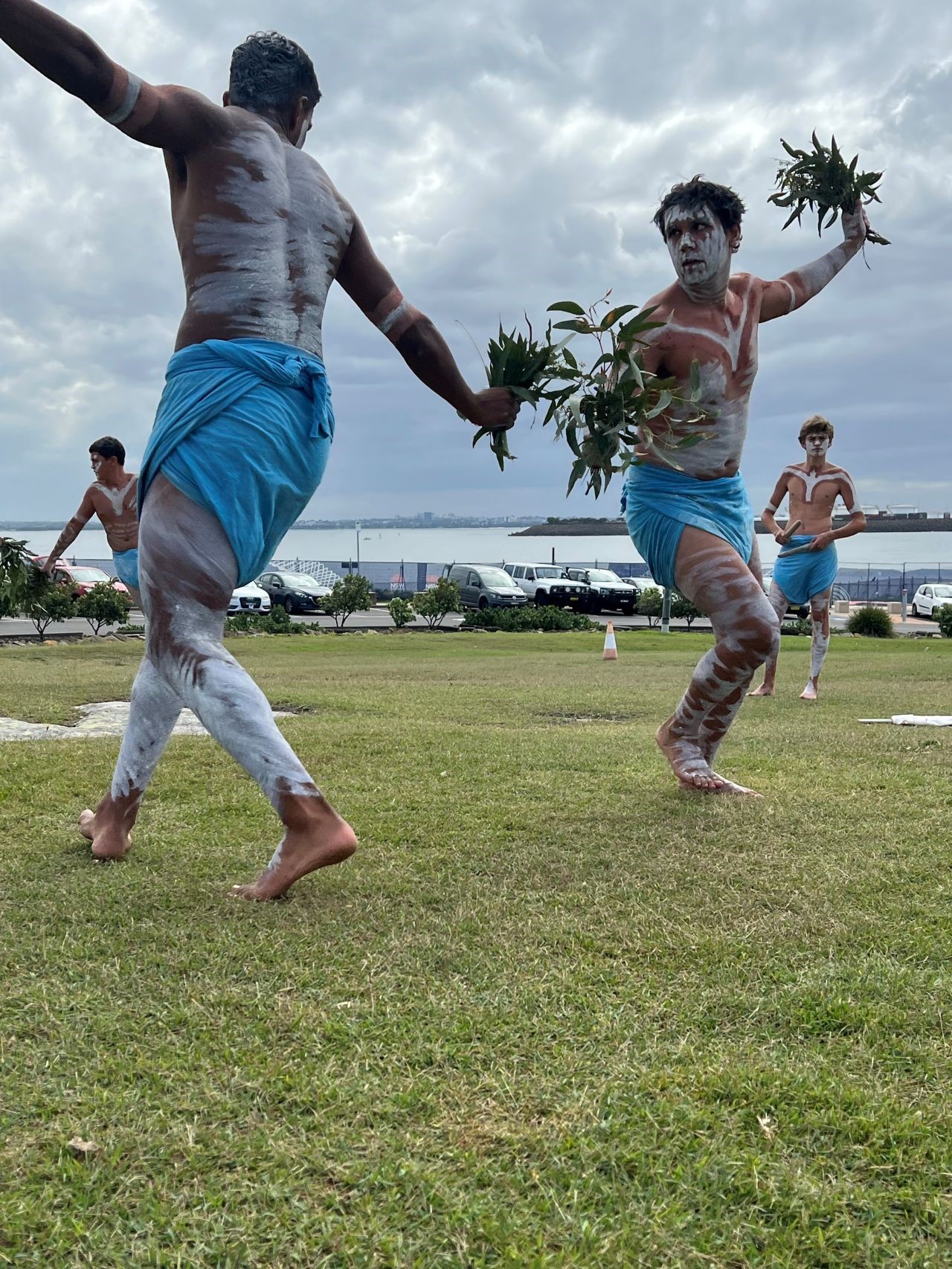 Two First Nations people perform a traditional dance outdoors