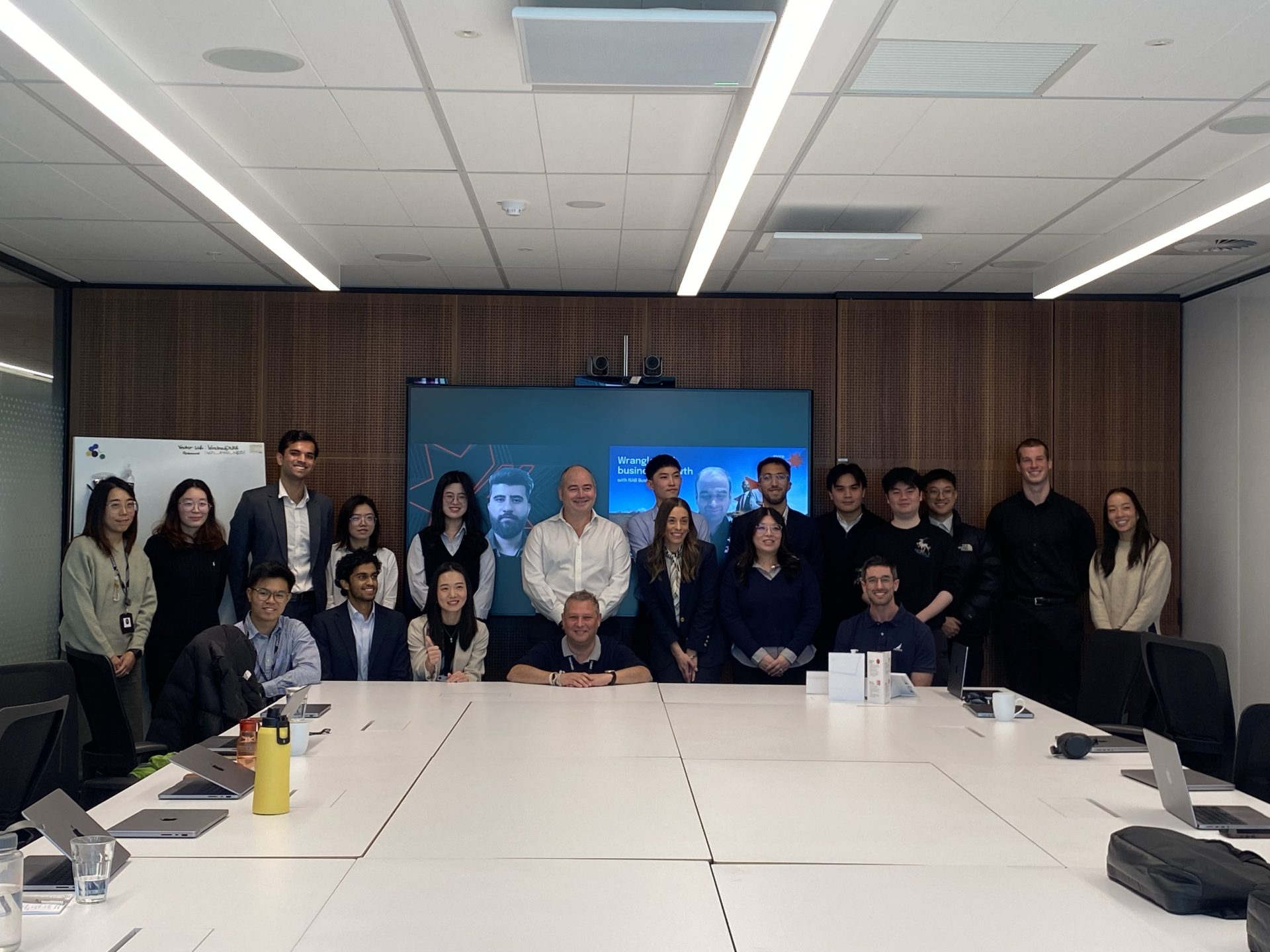 Group of NAB interns with the bank's CEO in a board room