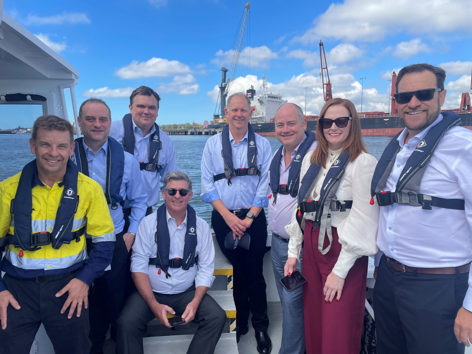 Photograph of a group of NAB and Port of Newcastle representatives on a boat.